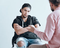 Teenager deep in thought during a therapy session Teenager deep in thought during a therapy session